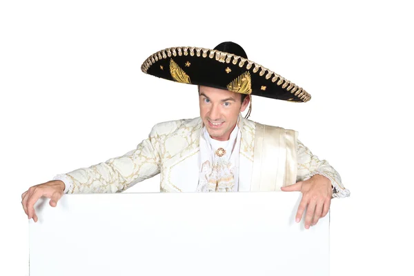 Man in a mariachi costume with a board left blank for your message — Stock Photo, Image