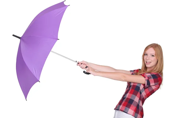Jovencita alegre con paraguas contra fondo de estudio —  Fotos de Stock