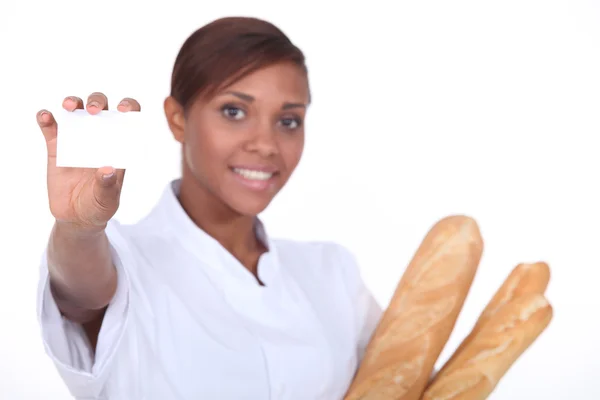Pretty baker showing her card — Stock Photo, Image