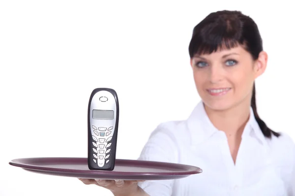 stock image Waitress with a cell phone on a tray