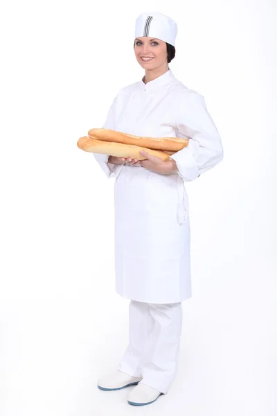 Baker with loaves of bread — Stock Photo, Image