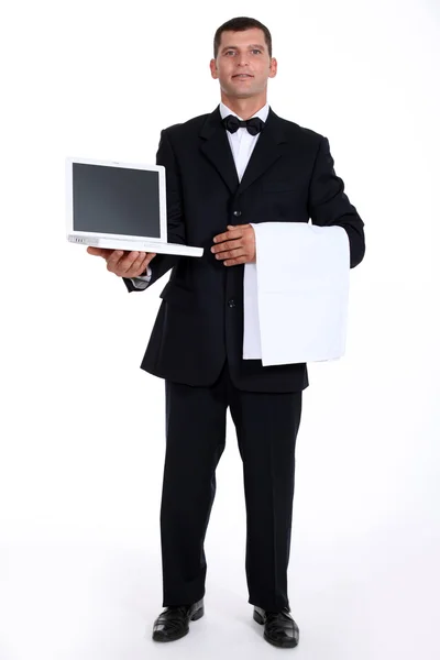 Waiter holding a laptop — Stock Photo, Image