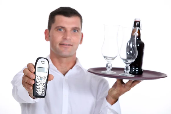 Bartender holding a tray and telephone — Stock Photo, Image