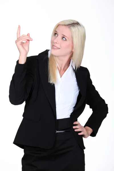 Businesswoman pointing her finger upwards — Stock Photo, Image