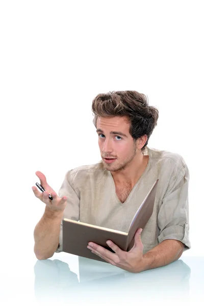 Man writing in a journal — Stock Photo, Image
