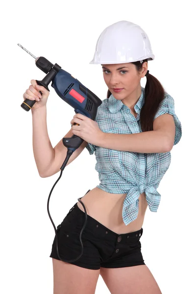 Sexy vrouw met behulp van een boormachine — Stockfoto