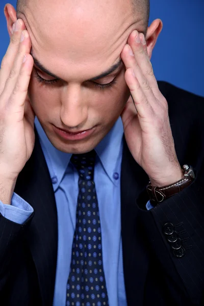 stock image Young bald businessman suffering from headache