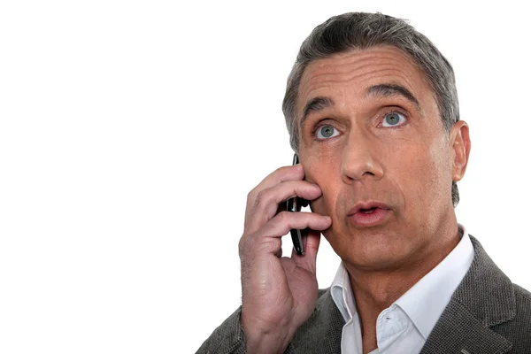 Confused man making telephone call — Stock Photo, Image