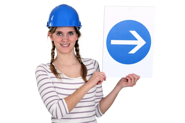Woman wearing hard hat and holding road sign — Stock Photo, Image