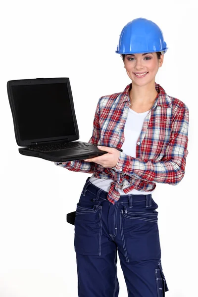 Female manual worker showing off laptop — Stock Photo, Image