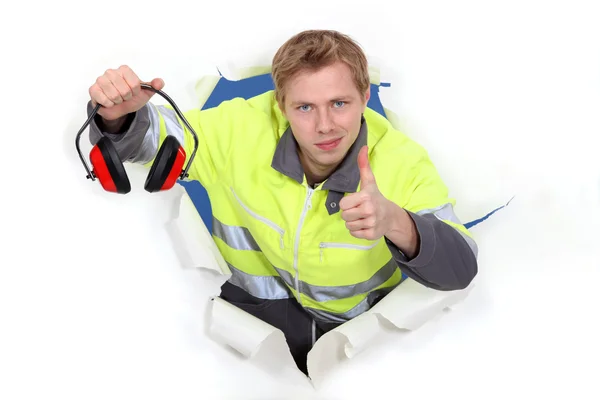 Worker giving the thumbs up to ear defenders — Stock Photo, Image
