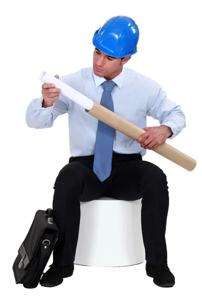 Architect with plans in a cardboard tube — Stock Photo, Image