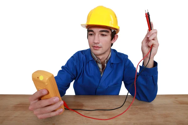 Tradesman using a multimeter — Stock Photo, Image