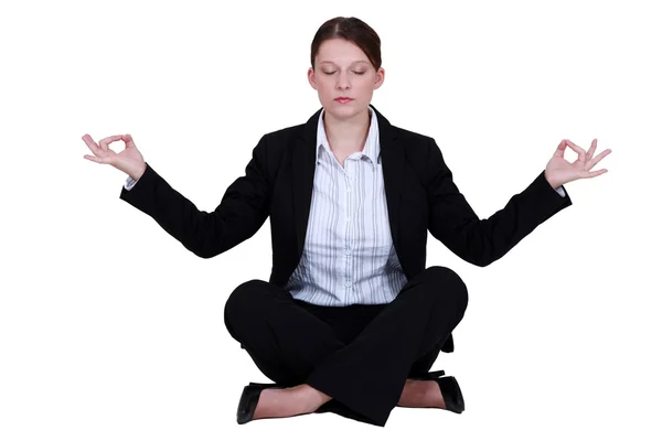 Employee relaxing in a yoga position — Stock Photo, Image