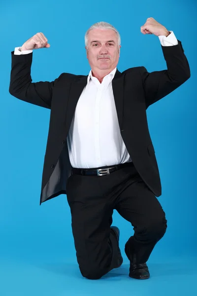 Businessman proudly showing his muscles — Stock Photo, Image
