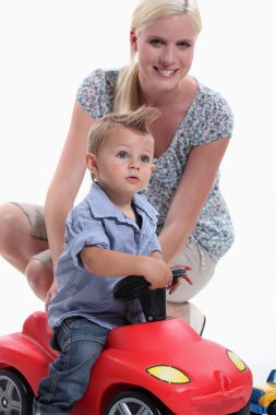 Mother and Child riding toy car clipart