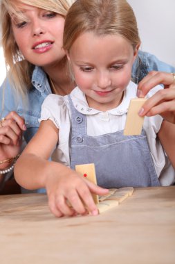 Child playing dominoes clipart