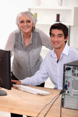 Elederly woman learning how to use computer clipart