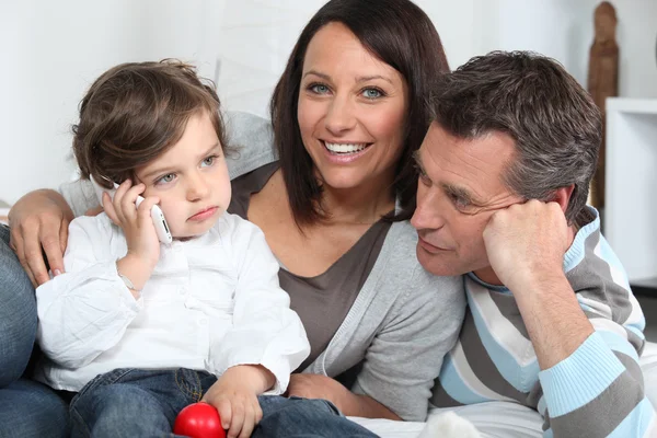 Happy young family sat together — Stock Photo, Image