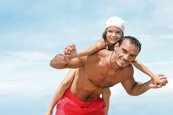 Girl on the back of father — Stock Photo, Image
