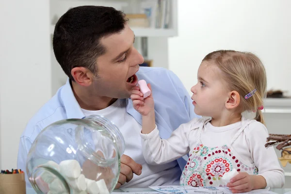 Apa és lánya evés édesség — Stock Fotó
