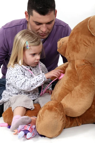 Little girl playing with teddy bear — Stock Photo, Image