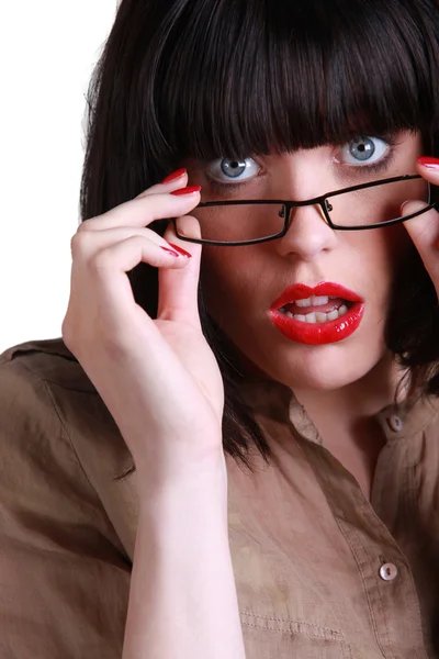 Shocked brunette lifting glasses frame — Stock Photo, Image
