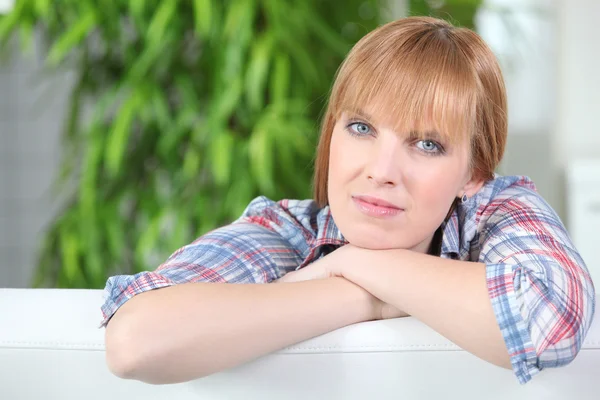 stock image Woman resting on couch back