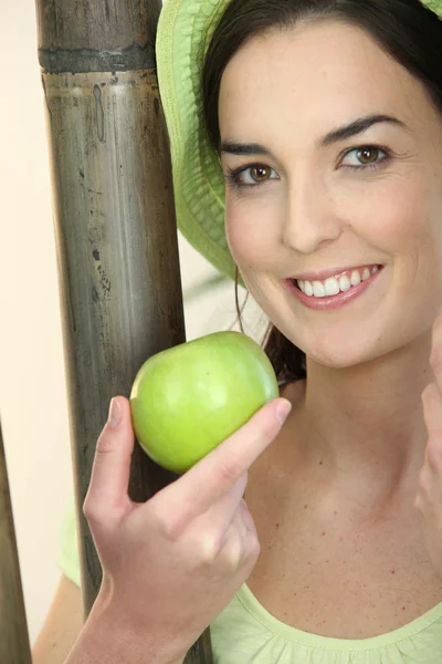 Kvinna som håller i ett äpple — Stockfoto