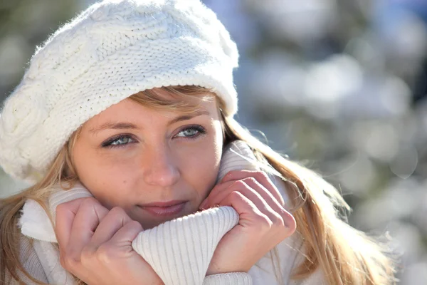 Woman snuggling up to her warm clothing — Stock Photo, Image