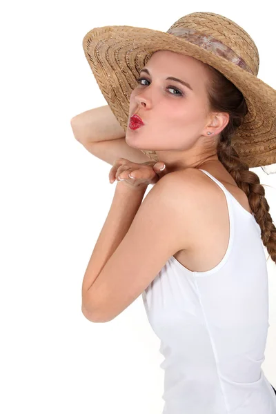 Beautiful young woman with straw hat and a long braid — Stock Photo, Image