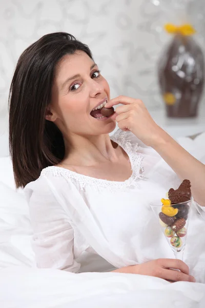 Woman eating Easter egg Stock Photo