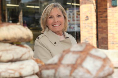 Woman behind loaves of bread clipart