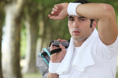 Man wiping sweat from his brow clipart