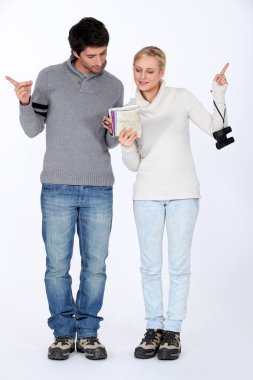 Couple reading a map clipart