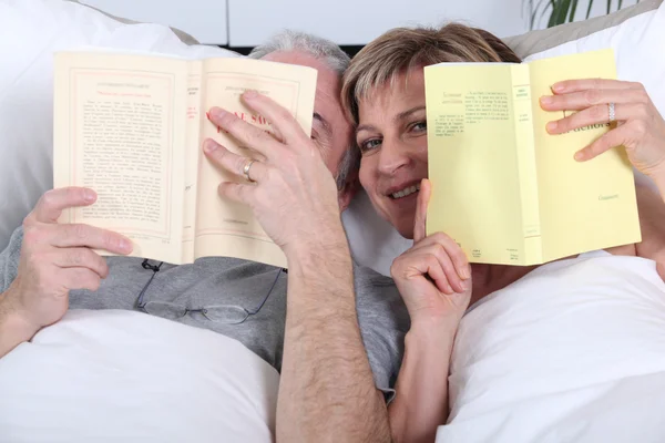 Leitura de casal na cama — Fotografia de Stock