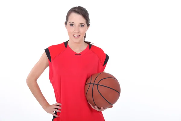 Female basketball player standing on white background — Stock Photo, Image