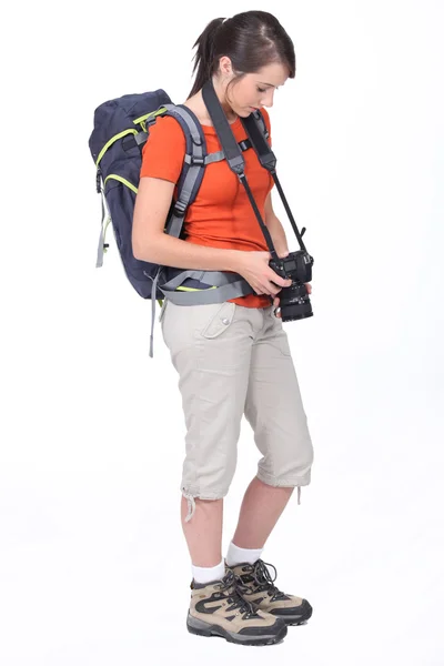 Cute female hiker with camera isolated on white — Stock Photo, Image