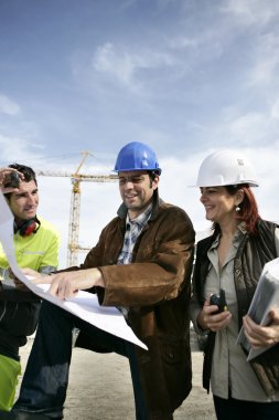 Teamwork on a building site clipart