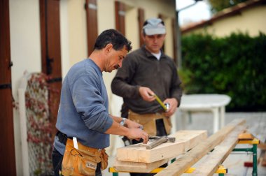 Two carpenters working on the same job clipart