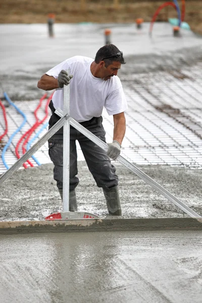 Man spreading wet cement — Stock Photo, Image