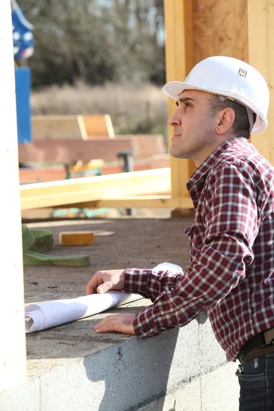 Foreman inspecionando o progresso da casa de madeira — Fotografia de Stock