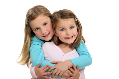 Two sisters hugging. clipart