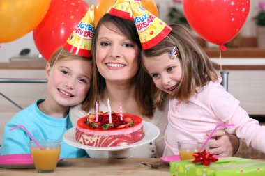 Woman celebrating a birthday with her kids clipart