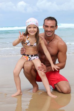 Father and daughter at the seaside clipart