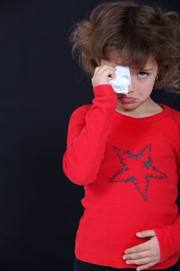 Crying child suffering from a stomach ache clipart