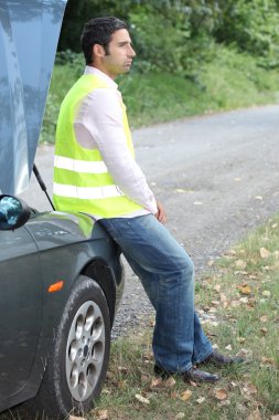 Man sat by broken-down car clipart