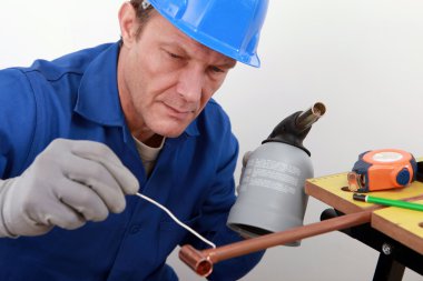 Craftsman working with a welding torch clipart