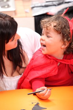 Mother sharing a moment with her daughter on Halloween clipart