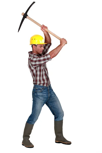 Craftsman working with a pick — Stock Photo, Image